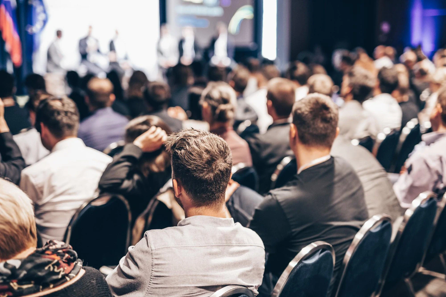 An audience following a presentation at an event