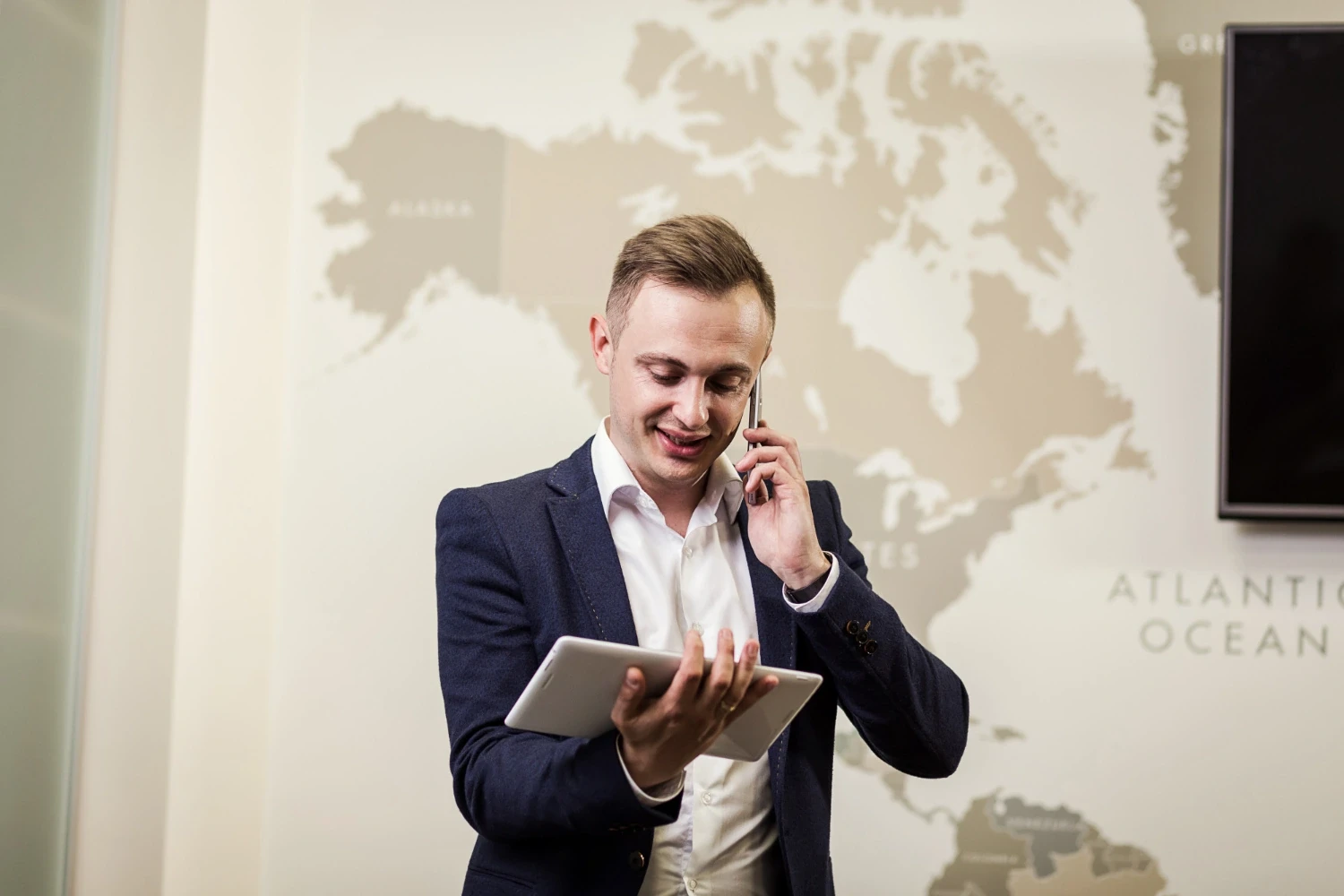 Salesperson on a call in front of a map of new markets